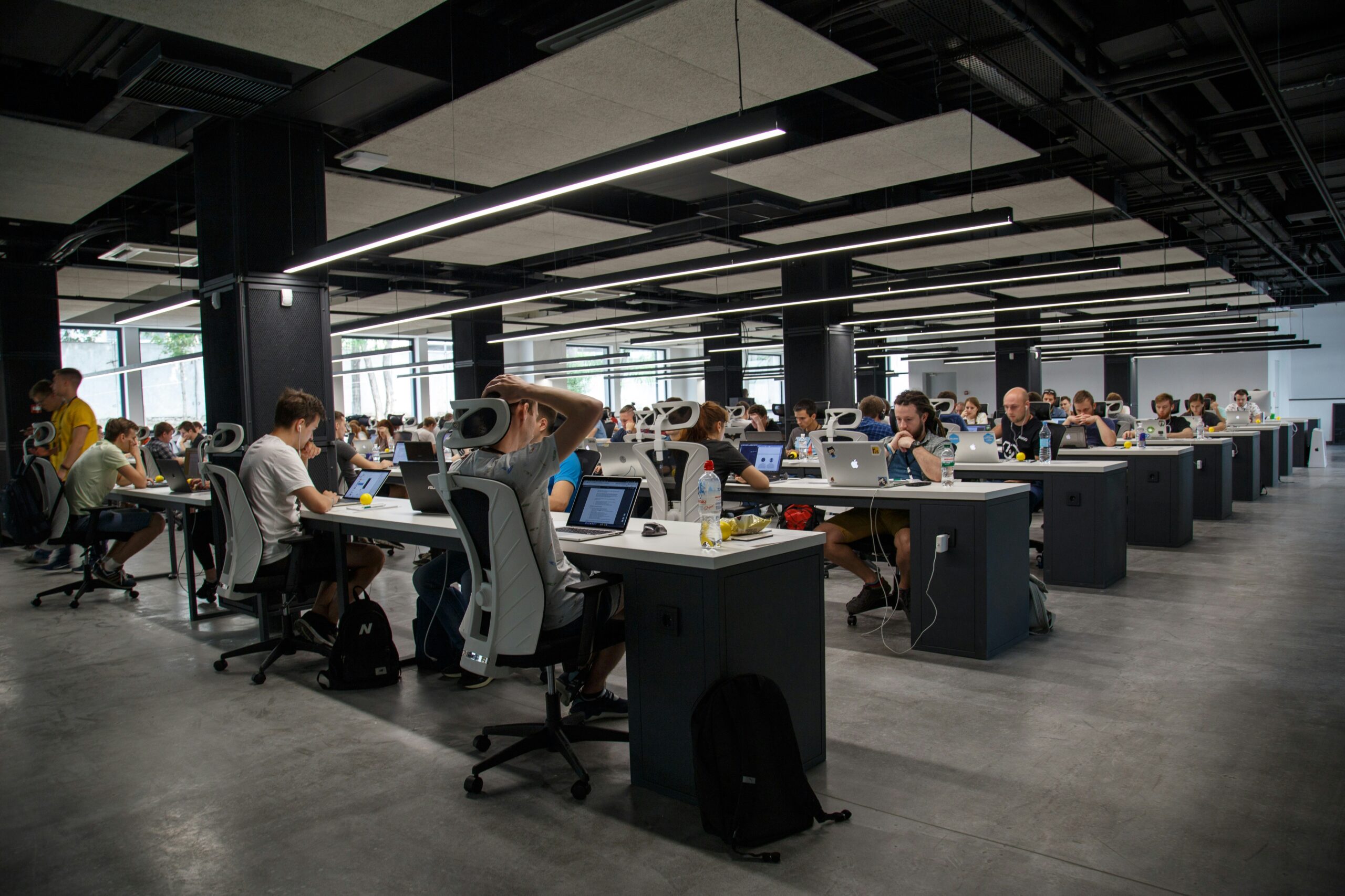 Open-plan office with a multitude of workers at their desks
