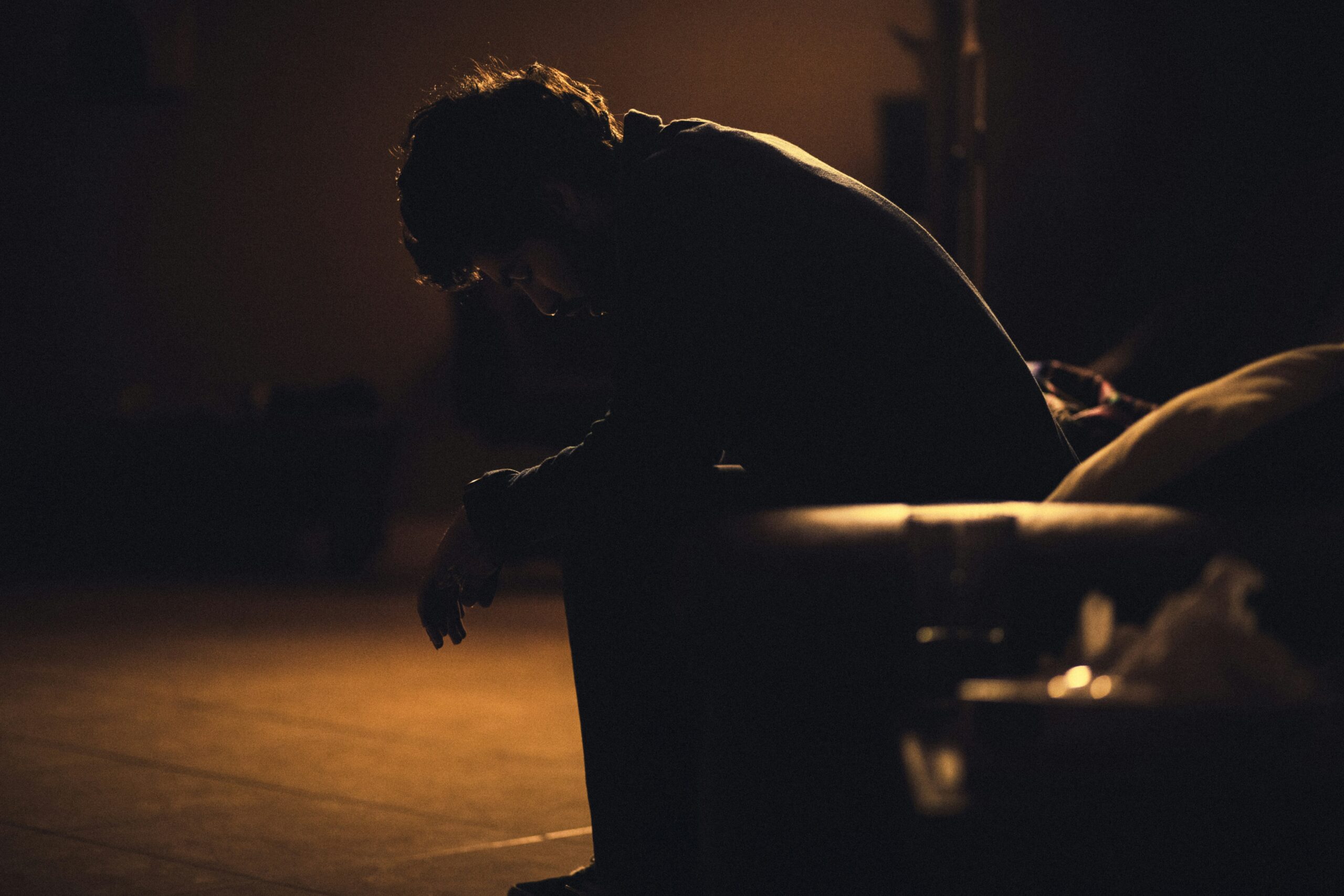 Person in a dark room as a symbolisation of depression