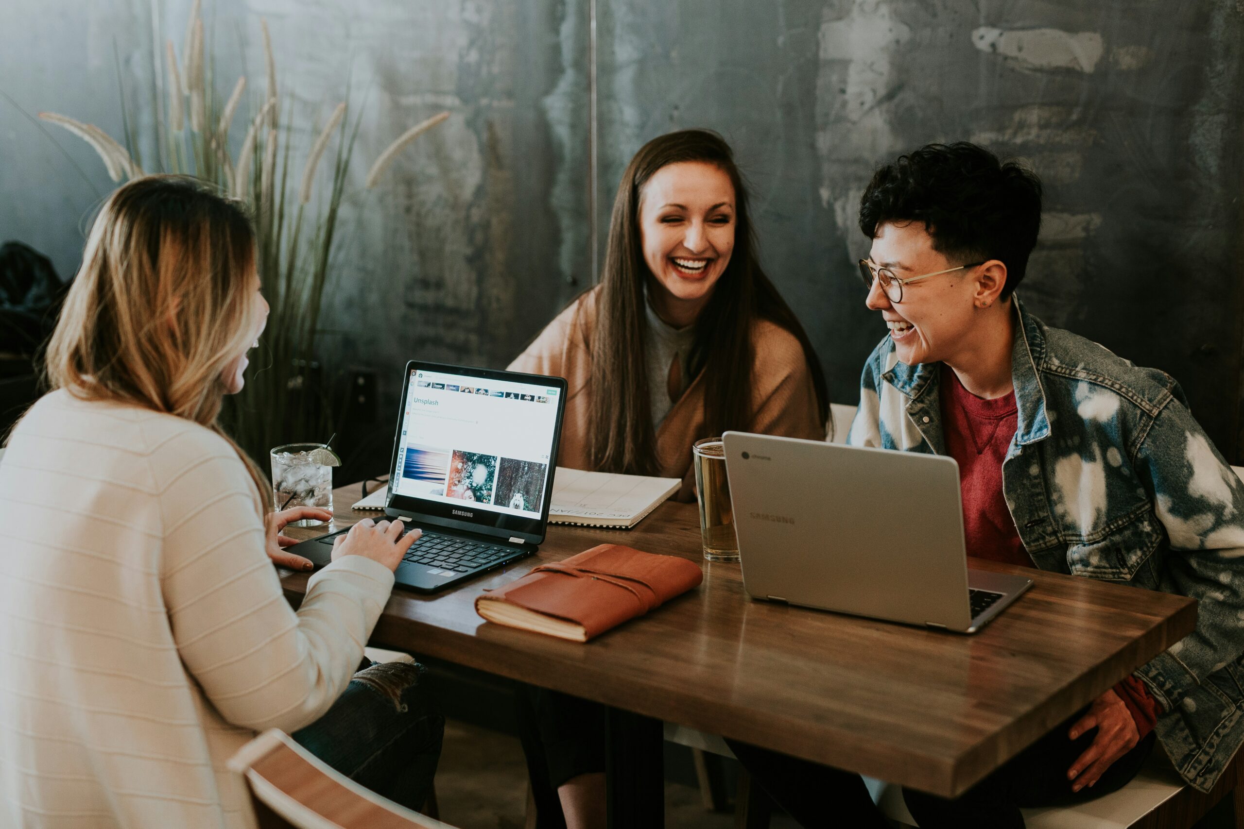 Group of coworkers laugh together as an example of a healthy work environment