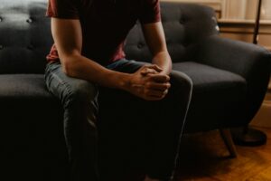 Male figure resting on a couch suggesting a therapy situation