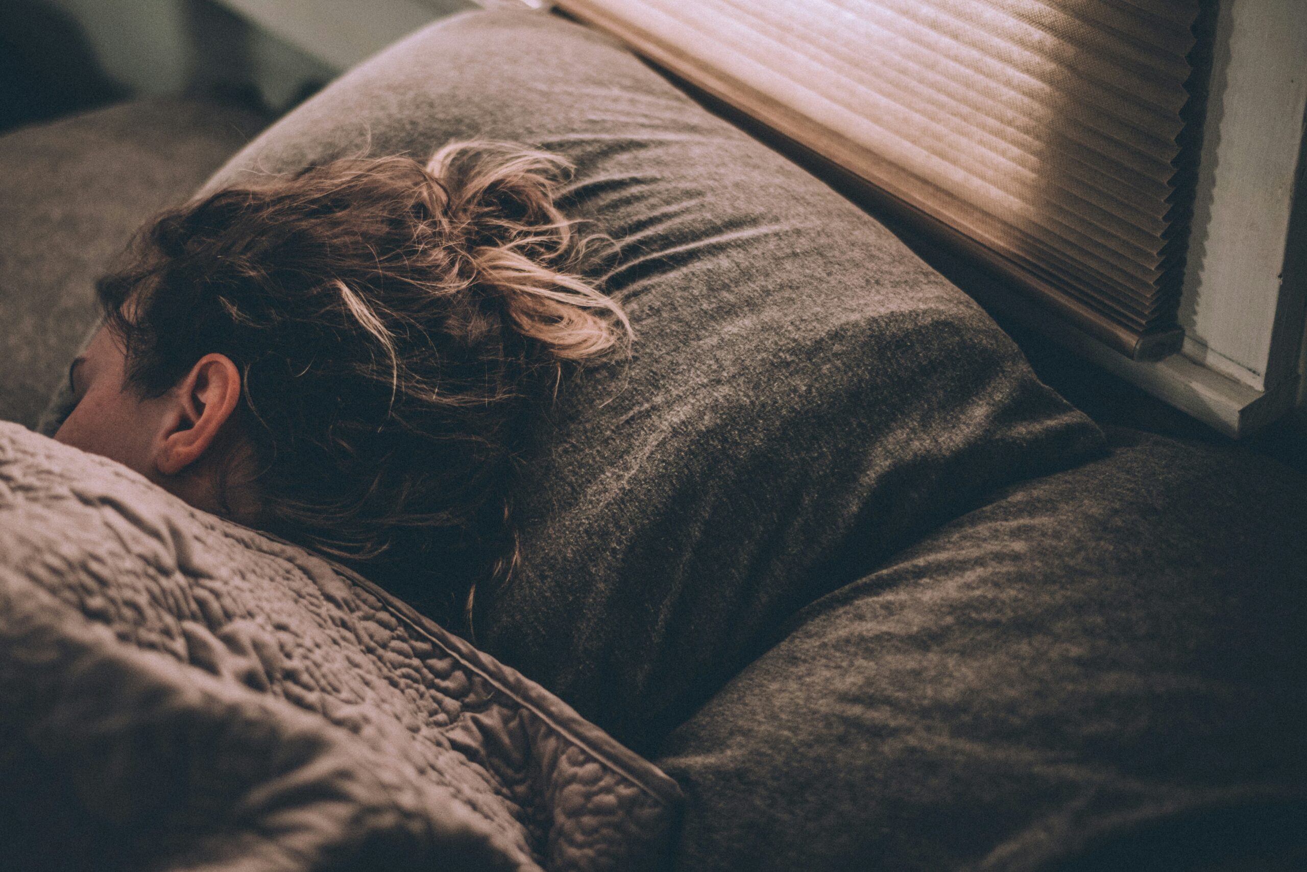 Person sleeping with their back to us