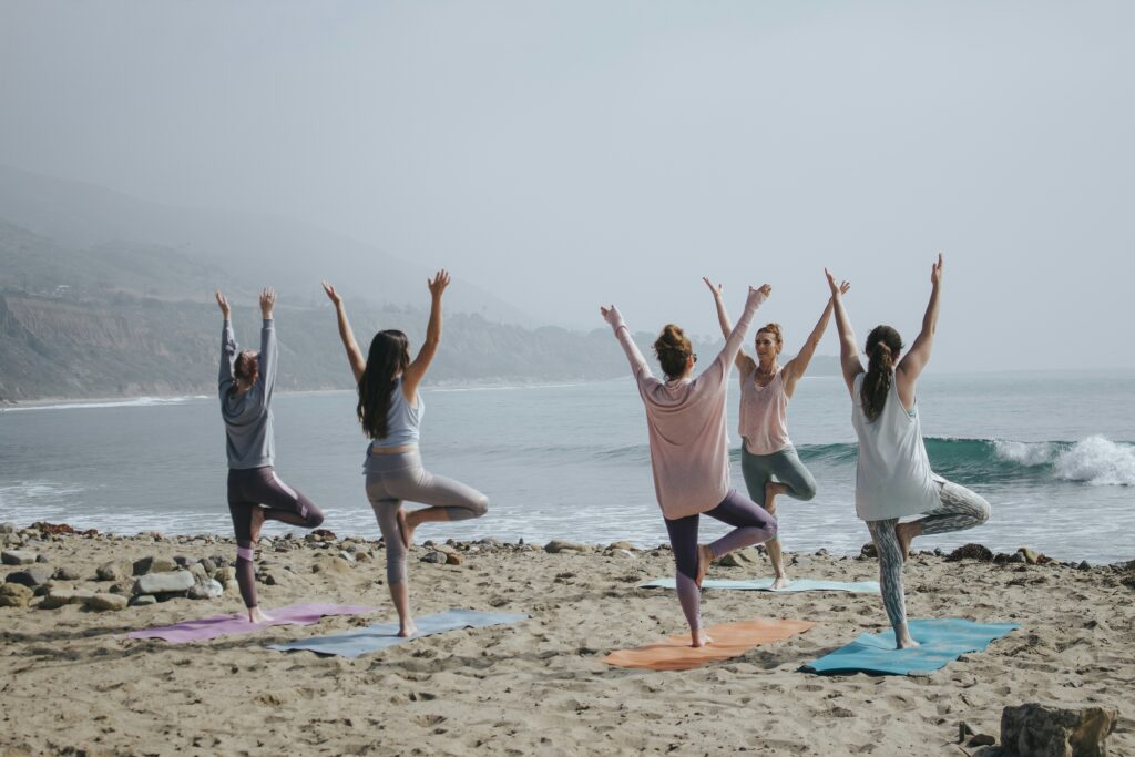 Group of people doing Yoga at the beach